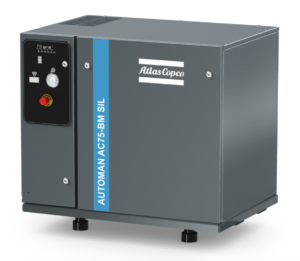 This is an image of a Atlas Copco AC75 - BM Silenced compressor part of the silent compressors range. It is a grey machine with white Atlas Copco branding and the Atlas Copco Blue strip. It features a red button and white pressure gauge. Because this compressor is so silent it is ideal for use within a closed working environment.